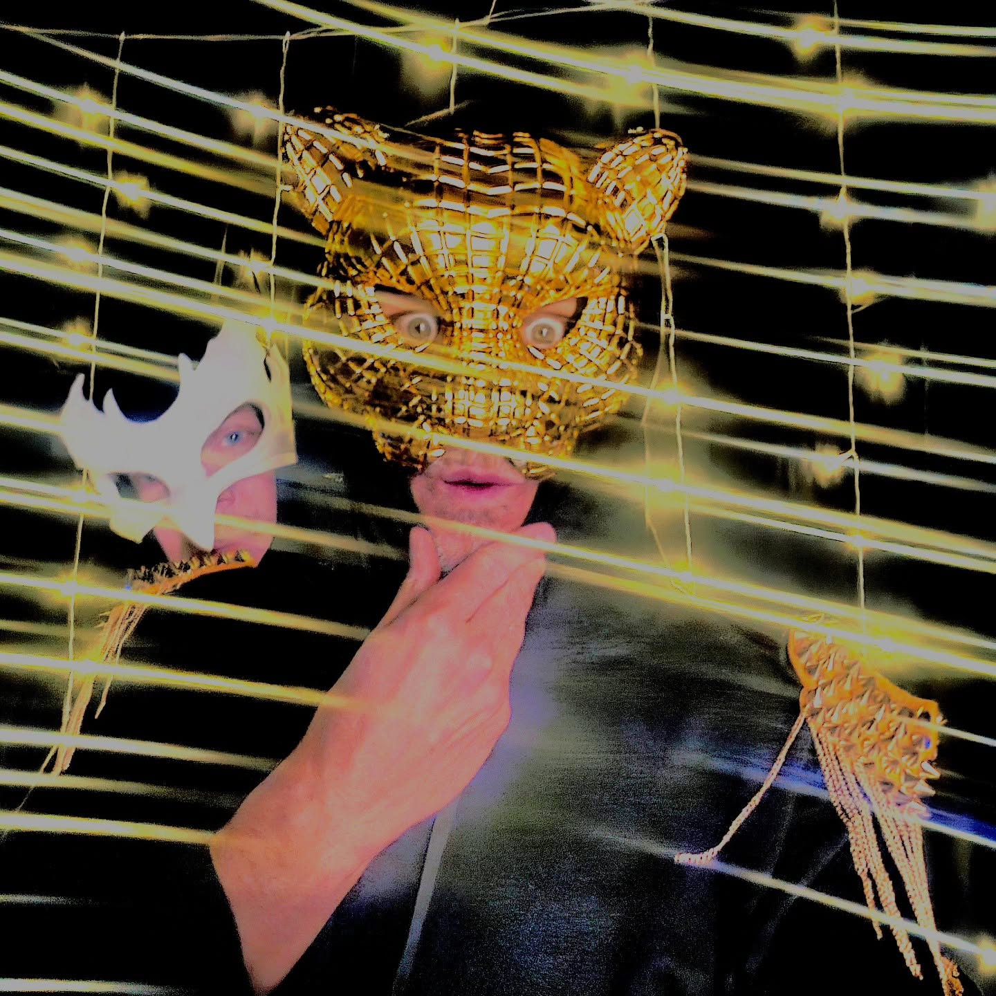 A gold tiger mask behind bright strings of lights
